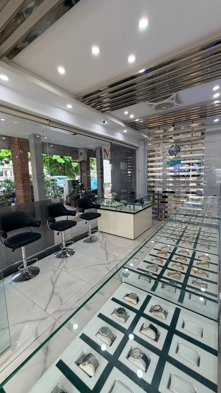 Glass cabinets of luxury watches inside the W. Watch store